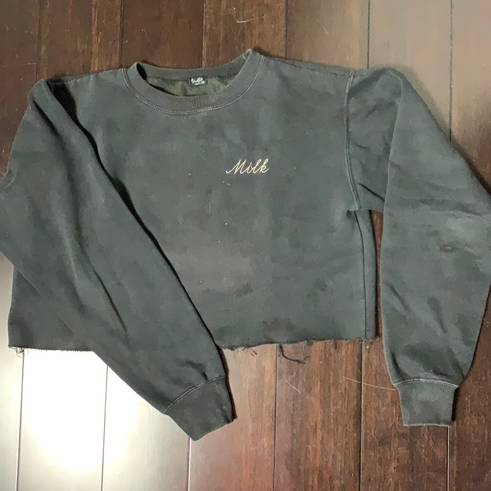 Black cropped sweater with word MILK sewn on it